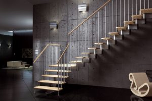 Central spine staircase with beech or oak treads and painted steel spindles and a wooden handrail modular style staircase