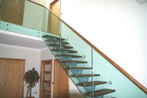 Cetral spine staircase feature oak treads with hardwax oil finish and frameless glass balustrade with oak handrails Aberdeen scotland1 e1471524927521