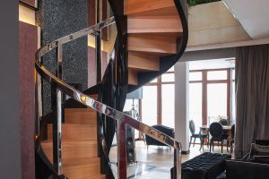 Contemporary helical spiral staircase oak treads and piano black high gloss finish and chrome balustrades London1