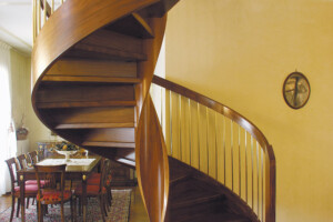 Helical spiral staircase created in Oak with bronzed spindles and helical feature outer banding on stair Helical spiral staircase created in Oak with bronzed spindles and helical feature outer banding on stair