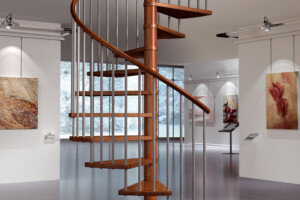 Modular spiral staircase in beech stained doussie with metal spindles and sectional wooden handrail Modular spiral staircase in beech stained doussie with metal spindles and sectional wooden handrail
