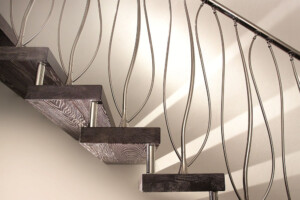 Floating staircase double curved stainless steel spindles and pickled oak finished stair treads Floating staircase double curved stainless steel spindles and pickled oak finished stair treads