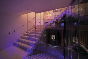 Nightclub zig zag feature staircase with glass wall and polished stainless steel handrails Nightclub zig zag feature staircase with glass wall and polished stainless steel handrails