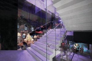 Zig zag night club staircase with frameless glass balustrade Zig zag night club staircase with frameless glass balustrade