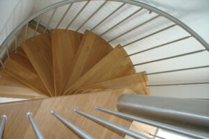 Closed riser oak spiral staircase natural hardwax oil finish with brushed stainless steel spindles Lake Windermere Lake District Closed riser oak spiral staircase natural hardwax oil finish with brushed stainless steel spindles Lake Windermere Lake District