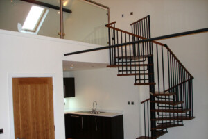 Spiral stair chestnut coloured beech treads with black spindles and a sectional handrail square shaped modular spiral staircase Leeds Spiral stair chestnut coloured beech treads with black spindles and a sectional handrail square shaped modular spiral staircase Leeds