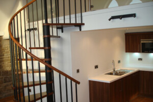 Spiral staircase with chestnut coloured beech treads and painted black spindles modular spiral stair leeds Spiral staircase with chestnut coloured beech treads and painted black spindles modular spiral stair leeds